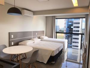 a hospital room with a bed and a table at ABC Apart Hotel in Brasília