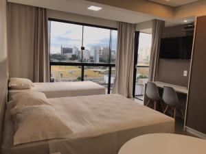 a hotel room with a bed and a television at ABC Apart Hotel in Brasilia