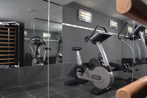 a gym with two exercise bikes and a mirror at Casa Camper Berlin in Berlin