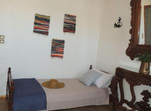a bedroom with a bed with a hat on it at Aloustina's House in Symi