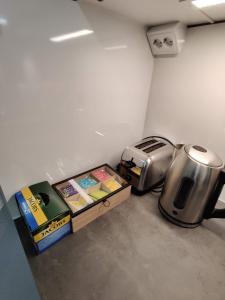 a kitchen with a toaster and boxes of food at Alexi Apartments - Newly Renovated Apt in the Heart of the City near to Railway Station and Nokia Arena in Tampere