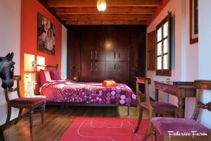 a bedroom with a bed and a desk and chairs at Agriturismo La Casa del Sarto in Pontremoli