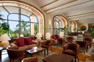 a lobby with a lot of furniture and windows at Grand Fiesta Americana Coral Beach Cancun - All Inclusive in Cancún