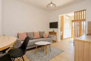 a living room with a couch and a table at Apartments & Rooms ARCH in Mostar