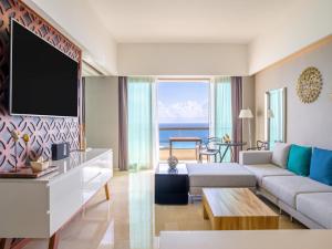 ein Wohnzimmer mit Sofa und Fernseher in der Unterkunft Live Aqua Cancun - Adults Only - All-Inclusive in Cancún