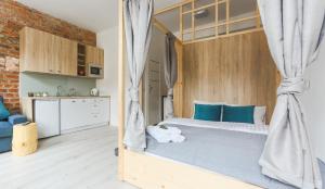 a bedroom with a large bed with blue pillows at Simply Modern Apartments in Toruń