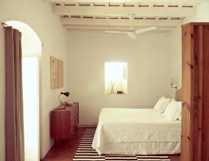 a bedroom with a bed and a ceiling fan at Siete Balcones y un patio in Vejer de la Frontera