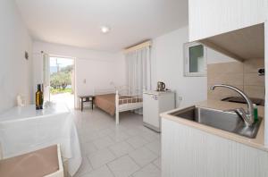 a kitchen with a sink and a counter top at Villa Giorgos in Kefalos