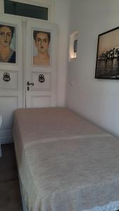 a bedroom with a bed and pictures on the wall at Arion suites Mykonos in Mýkonos City