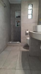 a bathroom with a sink and a toilet at Arion suites Mykonos in Mýkonos City