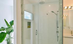 a bathroom with a shower with a glass door at The Flats West in Wellington