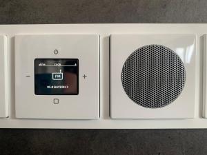 a white radio with a microphone on the side at Apartment Ihm in Memmingen