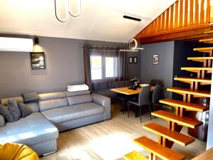 a living room with a couch and a dining table at Апартаменти за гости ,,Friends" in Teteven