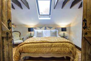a bedroom with a bed and a skylight at Unique Cottage The Old Stables Pembrokeshire Sleeps 8 - Welsh Tourist Board Award 5 Stars in Pembroke