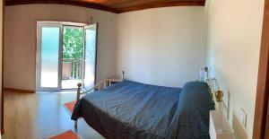 a bedroom with a bed and a window at Casa do Bairro Alto in Cerva