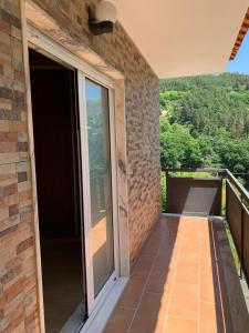 a balcony of a house with a view of the mountains at Casa do Bairro Alto in Cerva