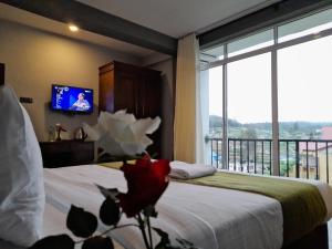 a hotel room with two beds and a tv at Tea Mount Forest in Nuwara Eliya