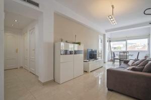 a white living room with a couch and a table at Apartment Marti in Barcelona