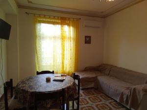 a living room with a couch and a table at Miramare Oliveri in Oliveri
