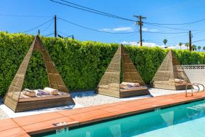 a group of lounges inront of a swimming pool at Saint Boniface Hotel in Indio