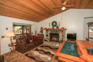 a living room with a couch and a fireplace at R & R Retreat - 1767 by Big Bear Vacations in Sugarloaf