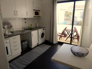 a kitchen with a sink and a washing machine at 2Stay- A0 in Ponta Delgada