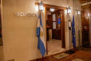a lobby with two flags on the side of a building at Hotel Villa Murano in San Cristóbal de Las Casas