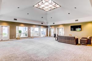 a large living room with a couch and windows at Fiddlers Cove in Hilton Head Island