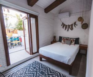 a bedroom with a bed and a large window at Amaia Boutique Hotel in Sayulita +31 photos