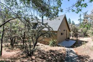 a small house in a field with a fence at Grandpas Axe-1775 by Big Bear Vacations in Big Bear Lake