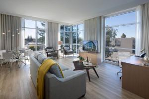 a living room with a couch and a tv and a table at Art House Hotel in Santa Rosa
