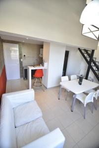 a living room with a white table and chairs at LAS MARAS SUITES in Viedma