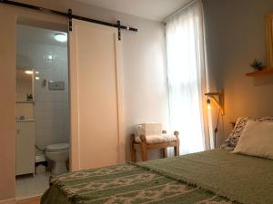 a bedroom with a bed and a bathroom with a toilet at Casa Olavarria in San Salvador de Jujuy