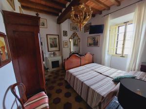 a bedroom with a bed and a chandelier at B&B la Forgia in Bettola