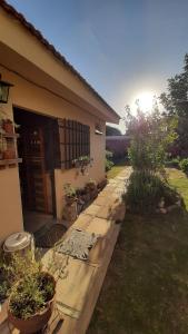 a house with a pathway leading to the front yard at La casita del colibri in Córdoba