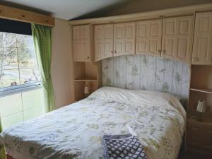 a bedroom with a bed with a canopy and a window at Asgard in Big Sand