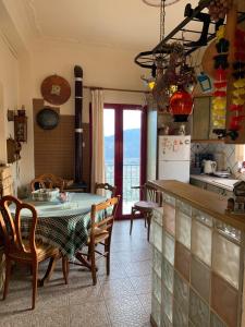 a kitchen and dining room with a table and chairs at Athena’s House in Elaión