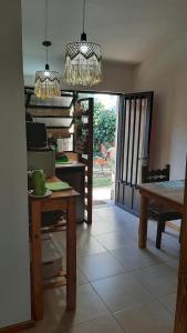 a kitchen with a table and a dining room at La casita del colibri in Cordoba