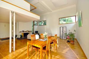 a dining room with a wooden table and chairs at Villa Ohaijo in Riga