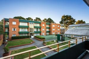 an apartment building with a courtyard in front of it at APX Parramatta in Sydney