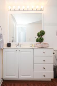 a white bathroom with a sink and a mirror at Ocean Reserve - Park View 1 Bedroom in Miami Beach