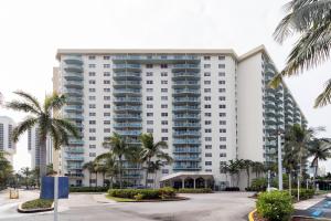 a large white building with palm trees in front of it at Ocean Reserve - Park View 1 Bedroom in Miami Beach