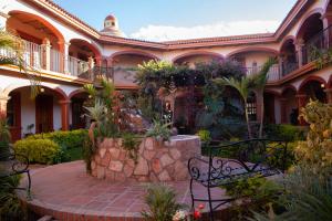 a building with a bench in front of it at Encanto de la Sierra Hotel in Mascota