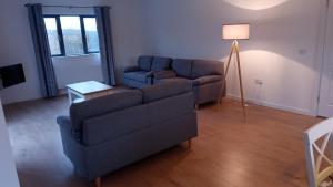 a living room with a couch and a lamp at Geevagh Holiday Home in Geevagh