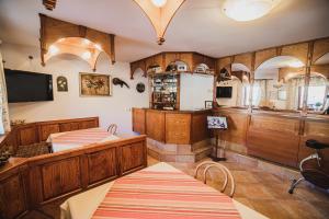 a room with two beds and a kitchen with wooden cabinets at Homestay Kocka in Zgornje Jezersko