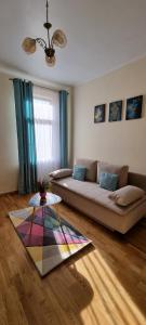 a living room with a couch and a table at Happy Mood Apartments in Braşov