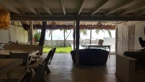 a restaurant with a table and chairs and a view of the ocean at Nordestina Casa de Mar in Icaraí