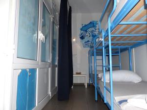 a room with two bunk beds and a window at Bedcelona Hostel in Barcelona