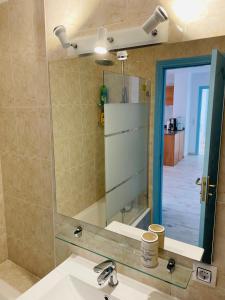 a bathroom with a sink and a mirror at Blue House Mallorca in Ses Salines