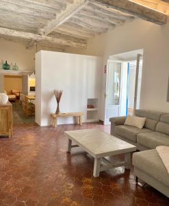 a living room with a couch and a coffee table at Can Marianet in San Ferrán de ses Roques